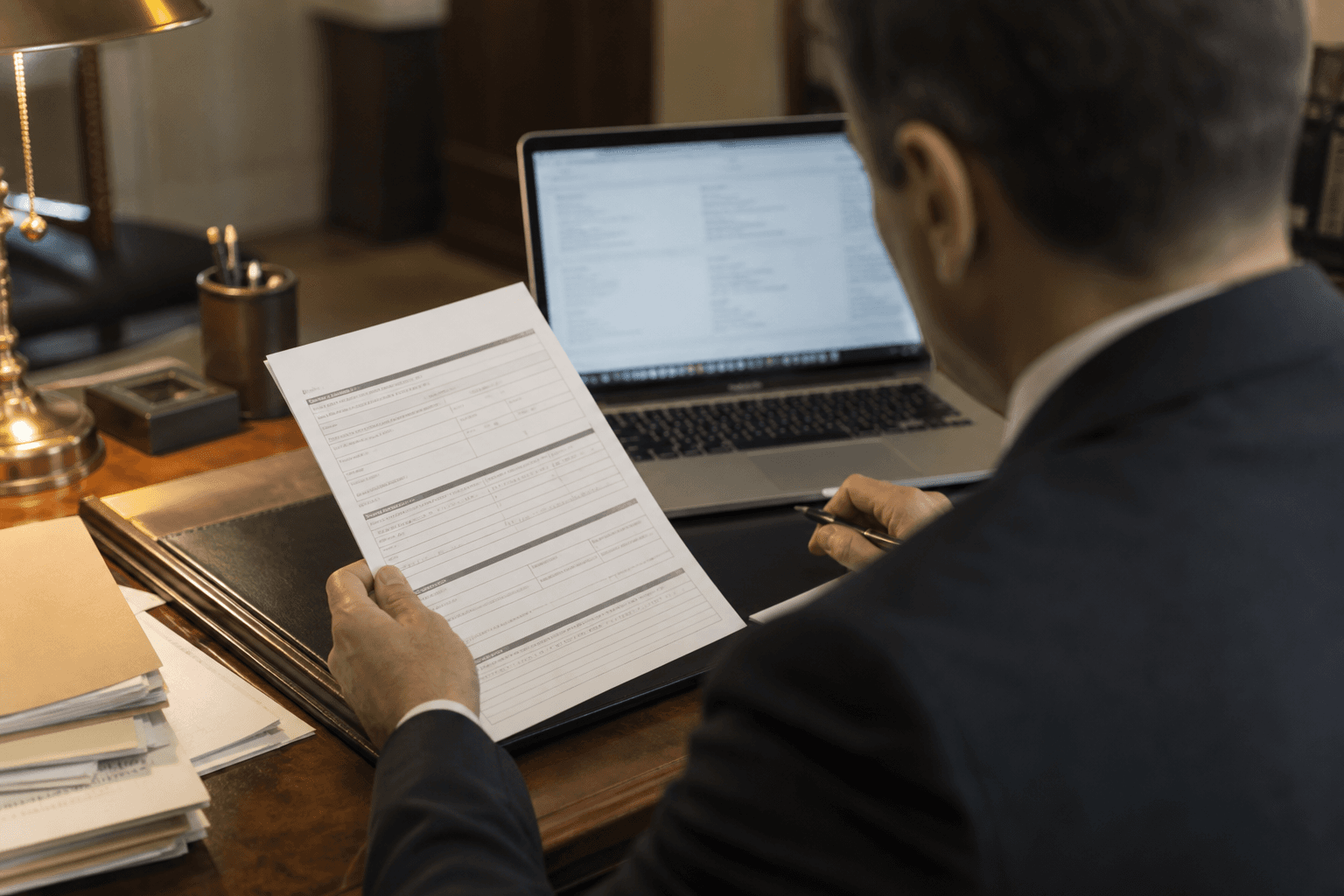 Attorney reviewing client intake materials at a desk